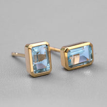 Load image into Gallery viewer, Blue Topaz Stud Earrings 14K Yellow Gold Emerald Cut