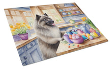 Load image into Gallery viewer, Decorating Easter Keeshond Glass Cutting Boards – Durable, Decorative Kitchen Art