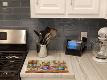 Load image into Gallery viewer, Decorating Easter Norwich Terrier Glass Cutting Boards – Durable, Decorative Kitchen Art