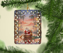 Load image into Gallery viewer, Cajun Santa Claus in the Pirogue Christmas Porcelain Ornament