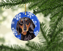 Load image into Gallery viewer, Dachshund Winter Snowflakes Holiday Ornament - Round Ceramic Ornament – Artist-Designed Keepsake Decoration SC9363