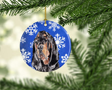 Load image into Gallery viewer, Black and Tan Coonhound Winter Snowflakes Ornament - Round Ceramic Ornament – Artist-Designed Keepsake Decoration SC9595CO1
