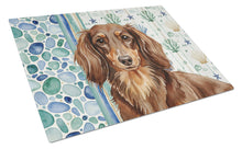 Load image into Gallery viewer, Longhaired Chocolate and Tan Dachshund Coastal Sea Glass Glass Cutting Board