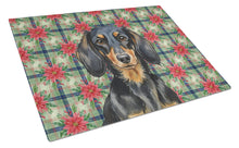 Load image into Gallery viewer, Longhaired Black and Tan Dachshund Christmas PoinsettIas Glass Cutting Board