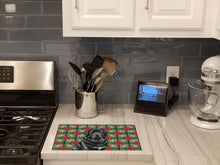 Load image into Gallery viewer, Black Tibetan Mastiff Christmas PoinsettIas Glass Cutting Board