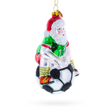 Load image into Gallery viewer, Santa Sitting on Soccer Ball Glass Christmas Ornament