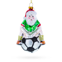 Load image into Gallery viewer, Santa Sitting on Soccer Ball Glass Christmas Ornament