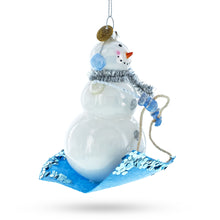 Load image into Gallery viewer, Snowman Riding a Sled Glass Christmas Ornament