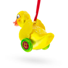 Load image into Gallery viewer, Yellow Duck Rolling on Wheels Glass Christmas Ornament