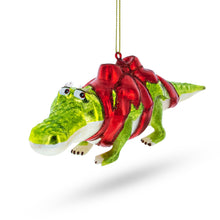 Load image into Gallery viewer, Alligator Adorned with Gift Ribbon Glass Christmas Ornament