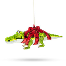 Load image into Gallery viewer, Alligator Adorned with Gift Ribbon Glass Christmas Ornament