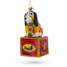 Load image into Gallery viewer, Playful Toy Dog on Festive Red Box Glass Christmas Ornament