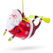 Load image into Gallery viewer, Santa Snowboarding Glass Christmas Ornament