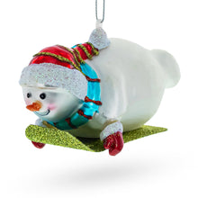 Load image into Gallery viewer, Snowman Gleefully Riding a Sled Glass Christmas Ornament
